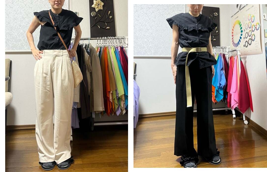 黒いフリルトップスを明るいパンツと黒いパンツで着こなす女性