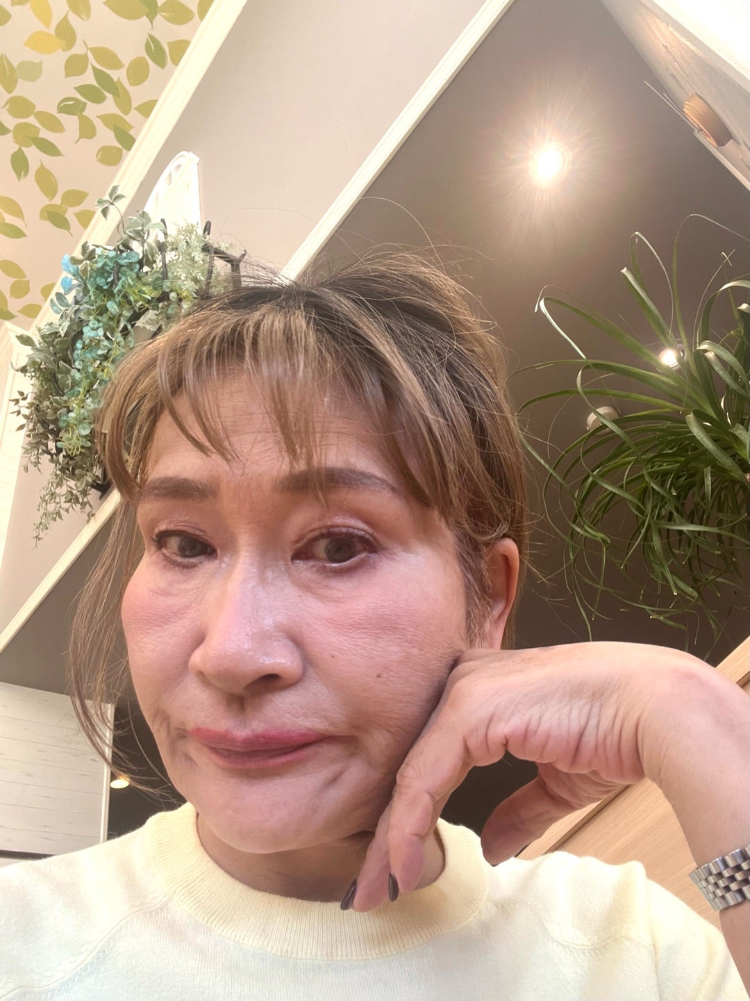 白いトップスとネックレスを合わせた由香さんの写真